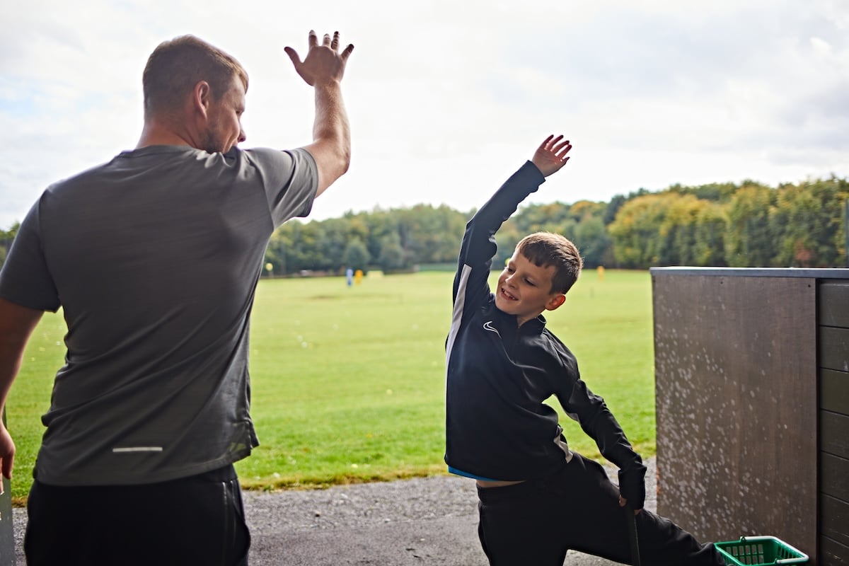 Father and son embracing a high-five together