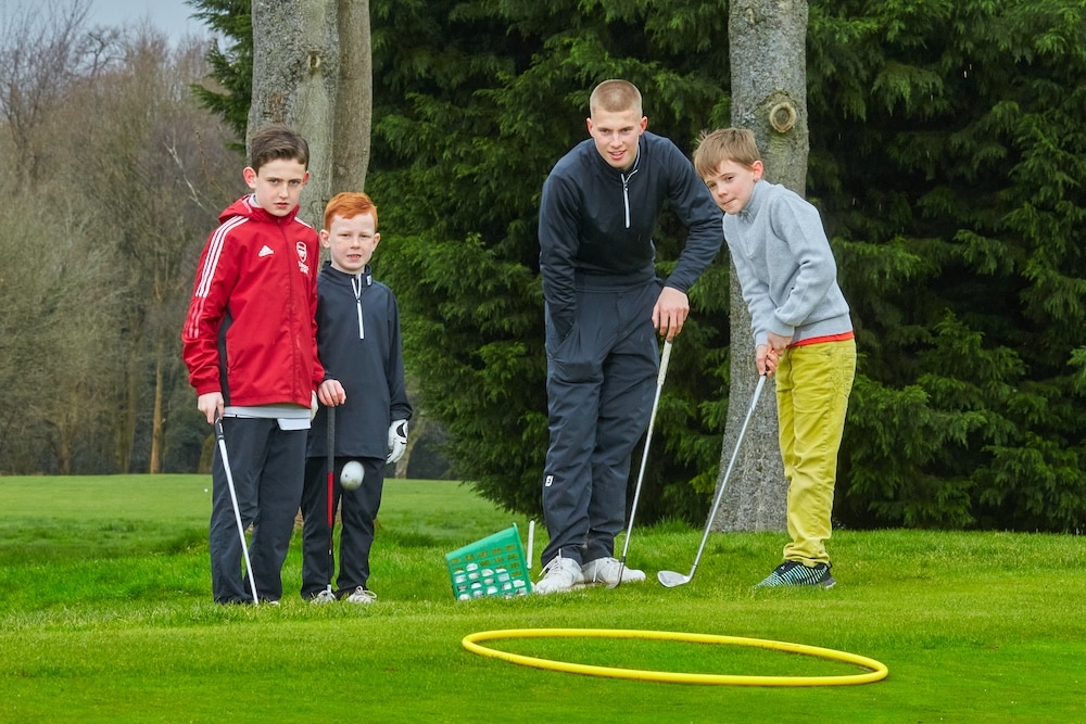 Professional delivering junior golf lessons